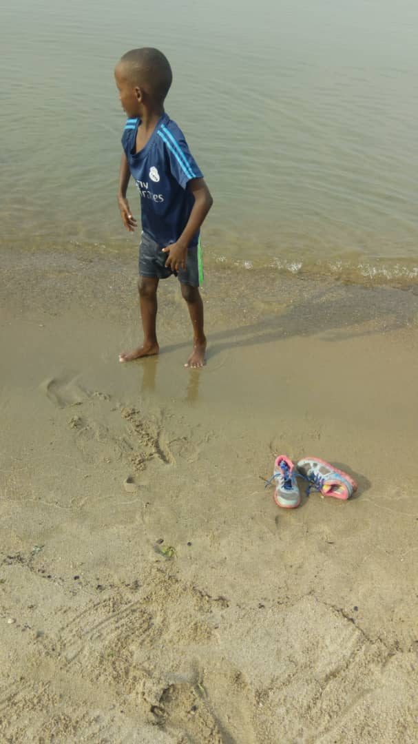 Boy playing at the lakeshore, Bujumbura
